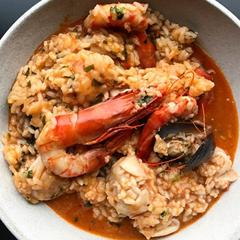 Traditional seafood rice sous-vide at Ferreira Café, Montreal, Québec
